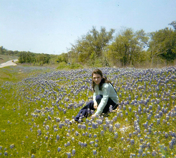In field of bluebonnets as a teenager. Copyright Kathy Carmichael.